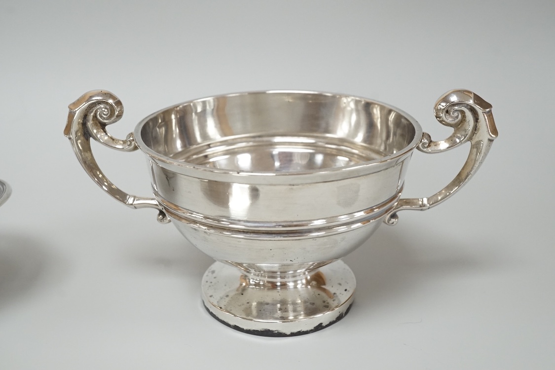 A George V silver mounted capstan inkwell, A & J Zimmerman Ltd, Birmingham, 1913, diameter 11.4cm, together with a small silver bowl, a small silver 'dish ring' salt(a.f.), a silver two handled bowl, a silver pill box an